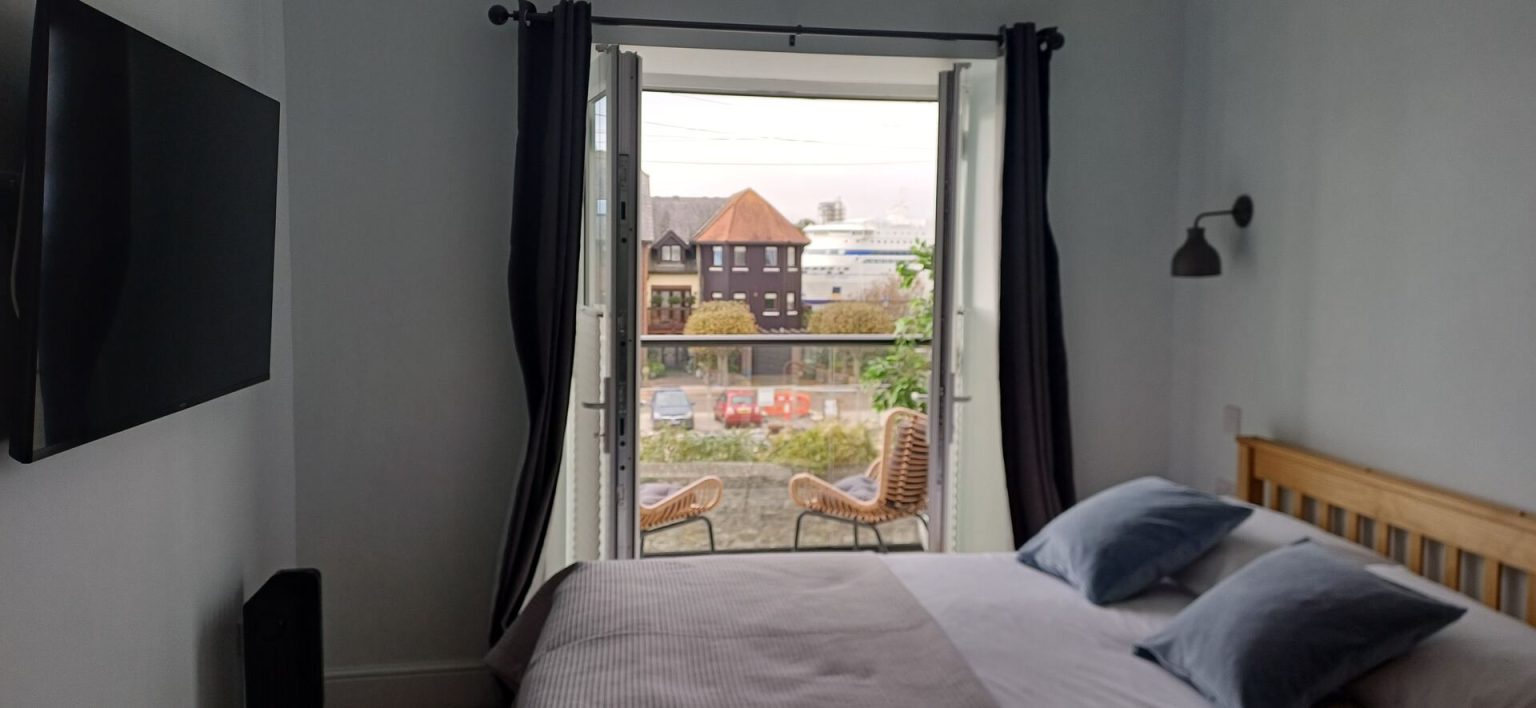 Coral Suite double bed facing the balcony with sea views